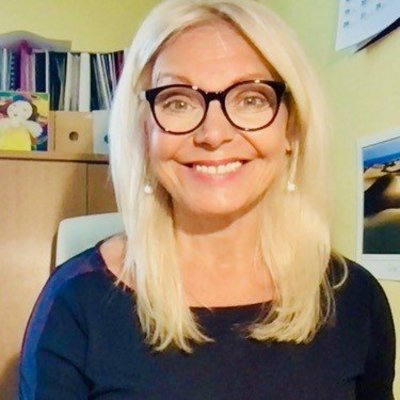 Usmievavá žena s dlhými blond vlasmi a okuliarmi