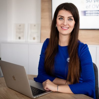 Usmievavá žena pri práci s laptopom